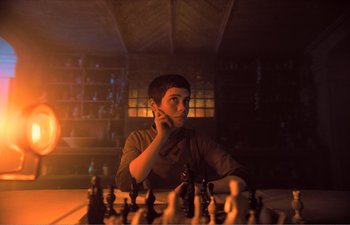 Movie still from “Gretel & Hansel” (2020), directed by Oz Perkins – A man sitting at a table with a chess set; Close Up shot, High angle