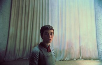 Movie still from “Gretel & Hansel” (2020), directed by Oz Perkins – A woman standing in front of a curtain; Medium shot, Low angle