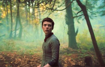 Movie still from “Gretel & Hansel” (2020), directed by Oz Perkins – A man standing in the middle of a forest; Medium shot, Low angle