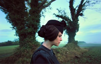 Movie still from “Gretel & Hansel” (2020), directed by Oz Perkins – A woman in a black hat and a black dress; Close Up shot, Low angle