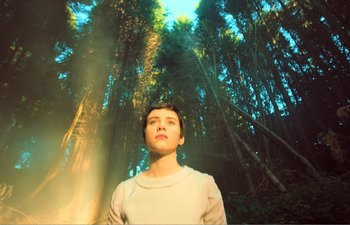 Movie still from “Gretel & Hansel” (2020), directed by Oz Perkins – A woman standing in the middle of a forest; Medium shot, Low angle