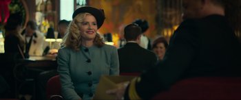 Movie still from “Greyhound” (2020), directed by Aaron Schneider – A woman wearing a hat and a suit; Medium shot, Over the shoulder angle