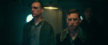 Movie still from “Greyhound” (2020), directed by Aaron Schneider – A couple of men standing next to each other; Medium shot, Low angle