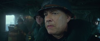 Movie still from “Greyhound” (2020), directed by Aaron Schneider – A man in a military uniform and a man in a helmet; Close Up shot, Low angle