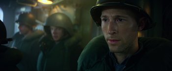 Movie still from “Greyhound” (2020), directed by Aaron Schneider – A person wearing a hat; Close Up shot, Over the shoulder angle