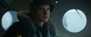 Movie still from “Greyhound” (2020), directed by Aaron Schneider – A man wearing a hat and a jacket; Close Up shot, Low angle