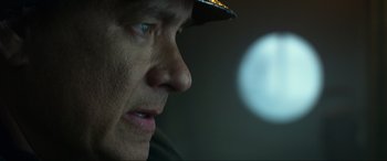Movie still from “Greyhound” (2020), directed by Aaron Schneider – A man's face with a hat on; Close Up shot, Low angle