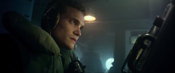 Movie still from “Greyhound” (2020), directed by Aaron Schneider – A man with headphones looking into the distance; Close Up shot, Low angle