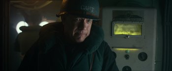 Movie still from “Greyhound” (2020), directed by Aaron Schneider – A person wearing a hat; Close Up shot, Low angle