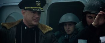 Movie still from “Greyhound” (2020), directed by Aaron Schneider – A man and a woman in military uniforms; Close Up shot, Over the shoulder angle