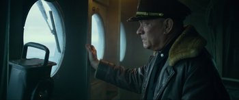 Movie still from “Greyhound” (2020), directed by Aaron Schneider – An older man in a hat looking out of a window; Close Up shot, Low angle