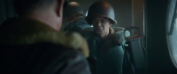 Movie still from “Greyhound” (2020), directed by Aaron Schneider – A group of men standing next to each other wearing helmets; Medium shot, Over the shoulder angle