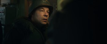 Movie still from “Greyhound” (2020), directed by Aaron Schneider – A man wearing a hat and a uniform; Close Up shot, Over the shoulder angle