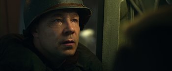 Movie still from “Greyhound” (2020), directed by Aaron Schneider – A man in a military uniform with tears in his eyes; Close Up shot, Over the shoulder angle