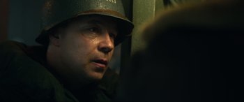 Movie still from “Greyhound” (2020), directed by Aaron Schneider – A man wearing a military hat and a helmet; Close Up shot, Over the shoulder angle
