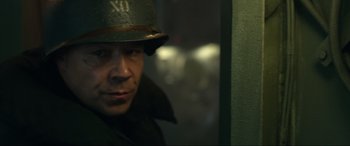 Movie still from “Greyhound” (2020), directed by Aaron Schneider – A man wearing a military hat and a jacket; Close Up shot, Over the shoulder angle