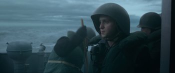 Movie still from “Greyhound” (2020), directed by Aaron Schneider – A man wearing a helmet while standing in the water; Medium shot, Low angle