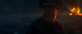 Movie still from “Greyhound” (2020), directed by Aaron Schneider – A man wearing a uniform and a hat; Close Up shot, Low angle