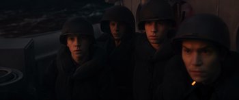 Movie still from “Greyhound” (2020), directed by Aaron Schneider – A group of young men wearing helmets and coats; Medium shot, High angle