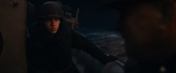 Movie still from “Greyhound” (2020), directed by Aaron Schneider – A man wearing a helmet and holding a sword; Medium shot, High angle