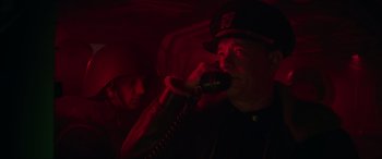 Movie still from “Greyhound” (2020), directed by Aaron Schneider – A man talking on a phone in a dark room; Close Up shot, Low angle