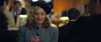 Movie still from “Greyhound” (2020), directed by Aaron Schneider – A woman wearing a hat is holding a pen in her hand; Close Up shot, Over the shoulder angle