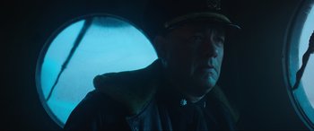 Movie still from “Greyhound” (2020), directed by Aaron Schneider – A man wearing a hat and a jacket; Close Up shot, Over the shoulder angle