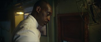 Movie still from “Greyhound” (2020), directed by Aaron Schneider – A man in a white dress shirt is looking down; Close Up shot, Low angle