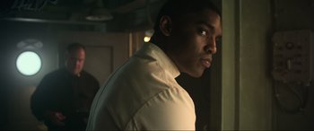Movie still from “Greyhound” (2020), directed by Aaron Schneider – A person wearing a white dress shirt; Close Up shot, Low angle