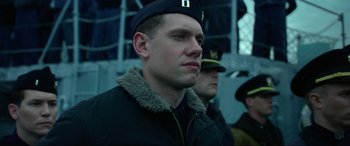 Movie still from “Greyhound” (2020), directed by Aaron Schneider – A person wearing a uniform; Close Up shot, Low angle