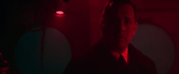 Movie still from “Greyhound” (2020), directed by Aaron Schneider – A man in a black shirt is in a red light; Close Up shot, Low angle
