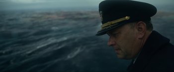 Movie still from “Greyhound” (2020), directed by Aaron Schneider – A person wearing a hat on a boat; Close Up shot, High angle