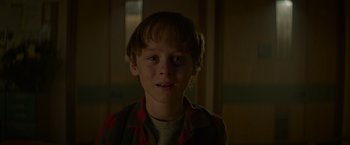 Movie still from “Guardians of the Galaxy” (2014), directed by James Gunn – A young boy is looking into the camera; Close Up shot, Over the shoulder angle