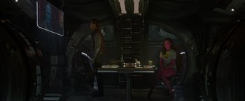 Movie still from “Guardians of the Galaxy” (2014), directed by James Gunn – A couple of people sitting at a dinner table; Wide shot, Over the shoulder angle