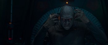Movie still from “Guardians of the Galaxy” (2014), directed by James Gunn – A man in a blue suit with headphones on his ears; Close Up shot, Low angle