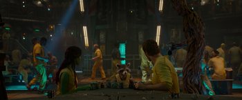 Movie still from “Guardians of the Galaxy” (2014), directed by James Gunn – A group of people standing around a table; Medium shot, Over the shoulder angle