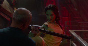 Movie still from “Guardians of the Galaxy” (2014), directed by James Gunn – A woman in a yellow shirt and a man in a black shirt; Medium shot, Over the shoulder angle