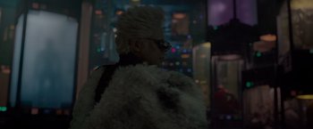 Movie still from “Guardians of the Galaxy” (2014), directed by James Gunn – A person with a white furry coat and sunglasses; Medium shot, Over the shoulder angle