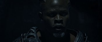 Movie still from “Guardians of the Galaxy” (2014), directed by James Gunn – A black man with blue eyes is looking at the camera; Close Up shot, Overhead angle