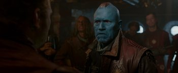 Movie still from “Guardians of the Galaxy” (2014), directed by James Gunn – A man with blue hair and a red face; Close Up shot, Over the shoulder angle