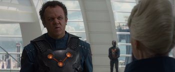 Movie still from “Guardians of the Galaxy” (2014), directed by James Gunn – A man in a costume standing next to another man in a costume; Medium shot, Over the shoulder angle
