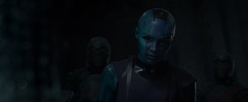Movie still from “Guardians of the Galaxy” (2014), directed by James Gunn – A woman in a blue suit and a man in a black suit; Close Up shot, Over the shoulder angle