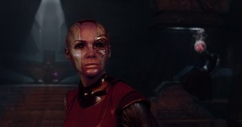 Movie still from “Guardians of the Galaxy” (2014), directed by James Gunn – A woman in a red shirt is standing in a dark room; Close Up shot, Over the shoulder angle