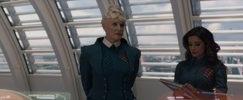 Movie still from “Guardians of the Galaxy” (2014), directed by James Gunn – An older woman with blonde hair wearing a green suit; Medium shot, Over the shoulder angle