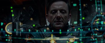 Movie still from “Guardians of the Galaxy” (2014), directed by James Gunn – A man in a suit with glowing lights; Close Up shot, Overhead angle