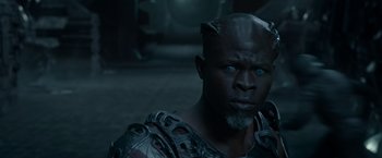 Movie still from “Guardians of the Galaxy” (2014), directed by James Gunn – A black man with blue eyes wearing a helmet; Close Up shot, High angle