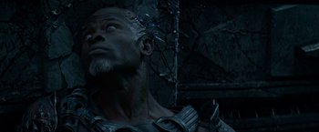 Movie still from “Guardians of the Galaxy” (2014), directed by James Gunn – A man with a beard and a helmet is looking up; Close Up shot, High angle