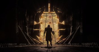 Movie still from “Guardians of the Galaxy” (2014), directed by James Gunn – A man is walking through an entrance to a building; Extreme Wide shot, Low angle