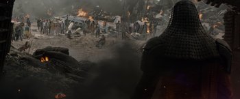 Movie still from “Guardians of the Galaxy” (2014), directed by James Gunn – A group of people standing in a field near a fire; Medium shot, Low angle