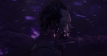 Movie still from “Guardians of the Galaxy” (2014), directed by James Gunn – A man with purple hair and a beard is standing in front of a purple background; Close Up shot, Low angle